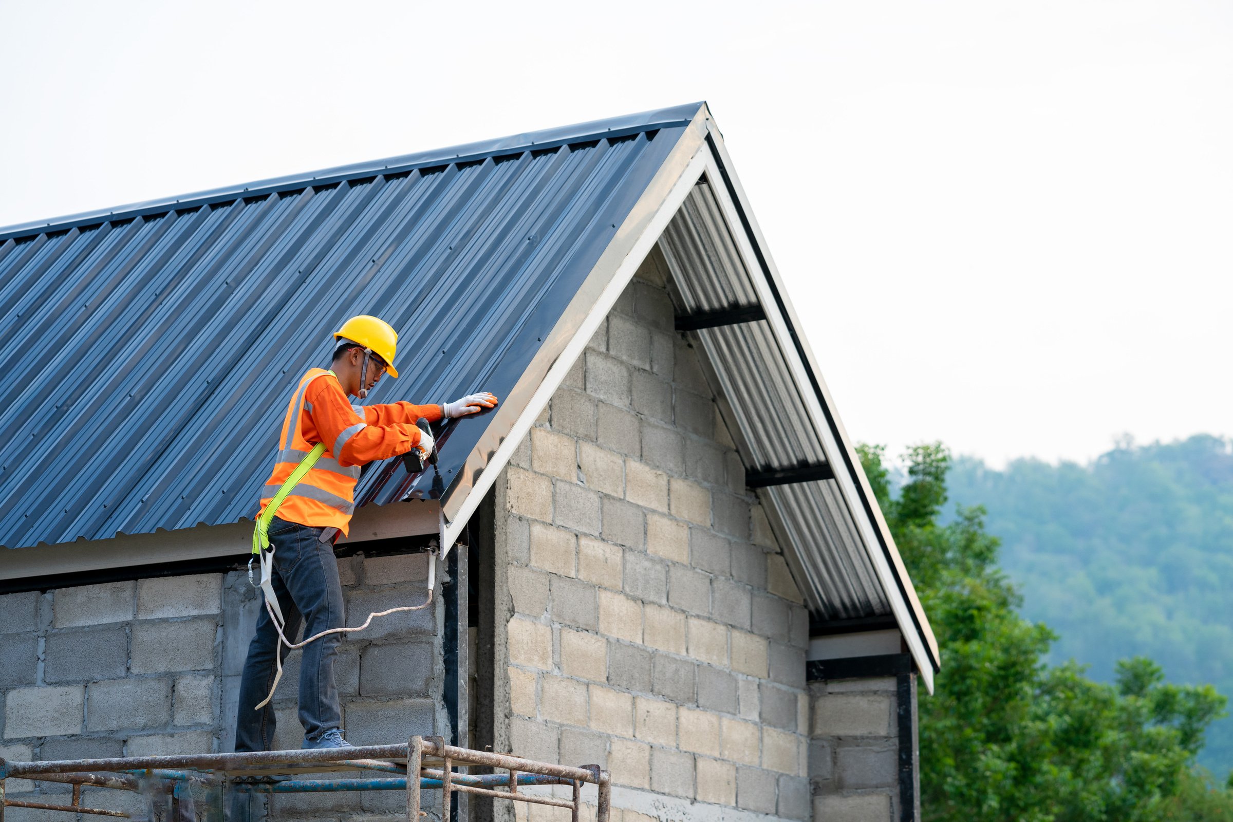 Construction Worker Installing New Roof on a House